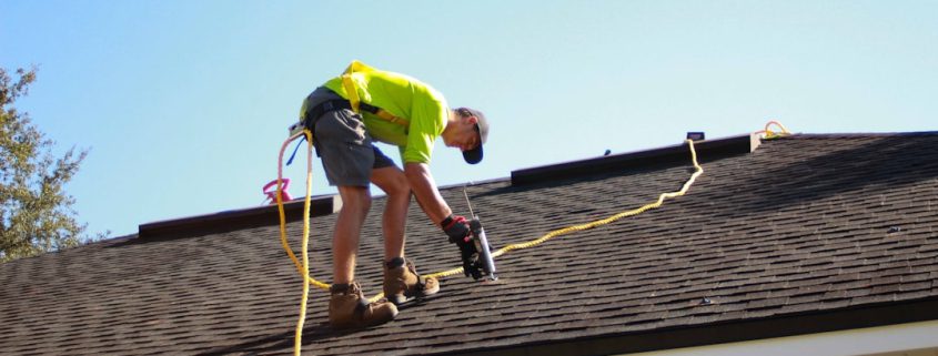 roof inspection professional examining shingles on residential home - how regular inspections prevent costly repairs