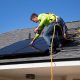 roof inspector examining shingles on residential home in Oregon - how regular inspections catch problems early