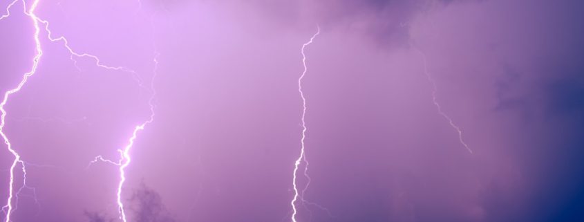 residential roof after severe windstorm with visible storm damage and displaced shingles - how weather events trigger the