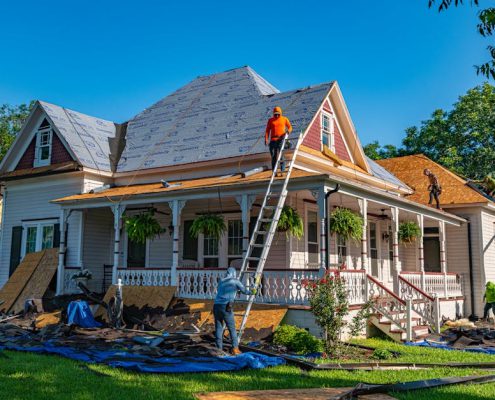 roofing contractor inspecting a beautiful home with a new roof in Beaverton Oregon - how to choose the right roofing