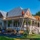 roofing contractor inspecting a beautiful home with a new roof in Beaverton Oregon - how to choose the right roofing