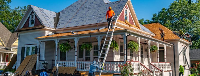 roofing contractor inspecting a beautiful home with a new roof in Beaverton Oregon - how to choose the right roofing