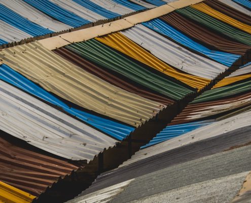 various roofing material samples including asphalt shingles metal and tile - roof replacement cost guide for homeowners