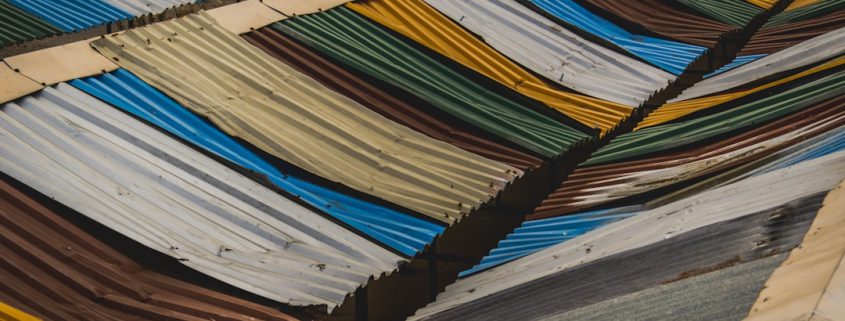 various roofing material samples including asphalt shingles metal and tile - roof replacement cost guide for homeowners