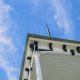 clean seamless gutters on a home with lush green Pacific Northwest landscaping - how gutter maintenance prevents foundation