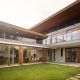 gutter systems on a modern home with water flowing through downspouts - gutter systems and why they matter for your roof