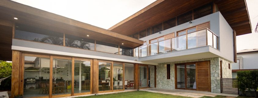 gutter systems on a modern home with water flowing through downspouts - gutter systems and why they matter for your roof