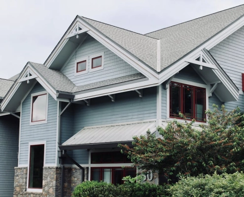 asphalt shingle vs metal roof comparison on a modern home