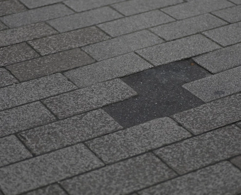 missing or damaged shingles on a residential roof after a storm