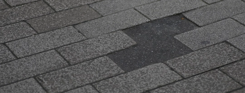 missing or damaged shingles on a residential roof after a storm